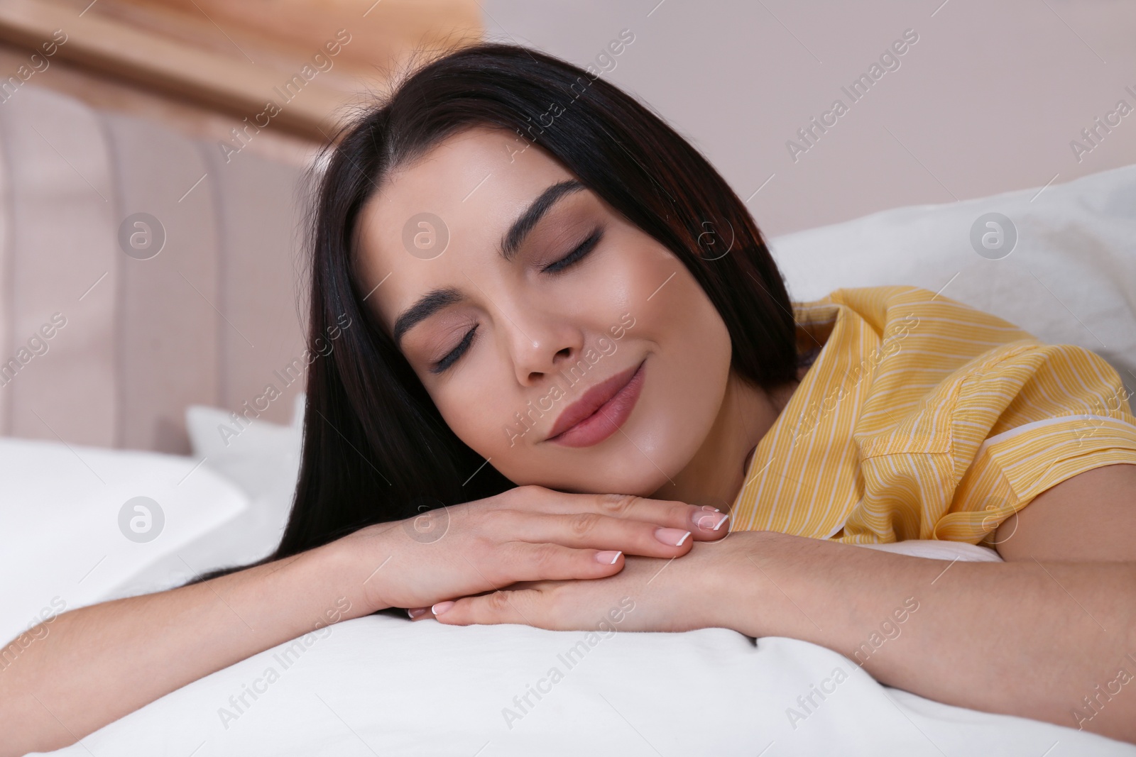 Woman sleeping in comfortable bed with white linens Photo of Woman sleeping in comfortable bed with white linens