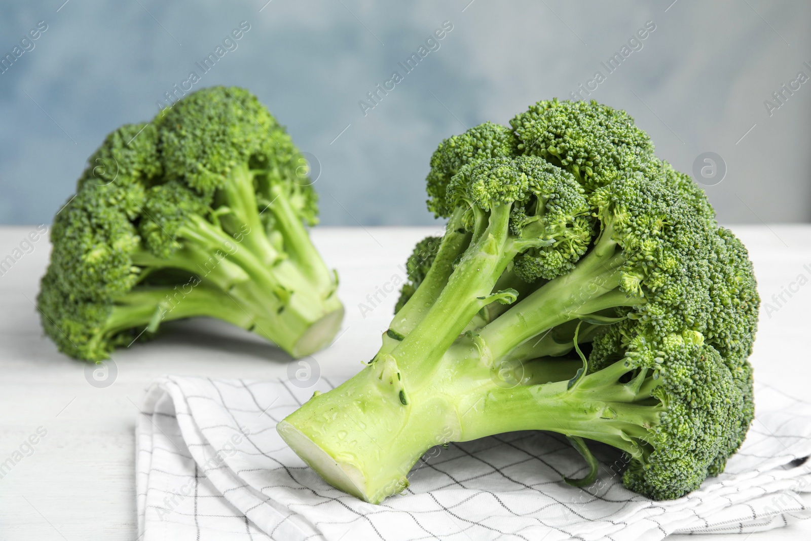 Fresh green broccoli on white wooden table, closeup Photo of Fresh green broccoli on white wooden table, closeup