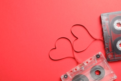 Music cassettes and hearts made of tape on red background, flat lay with space for text. Listening love songs Photo of Music cassettes and hearts made of tape on red background, flat lay with space for text. Listening love songs