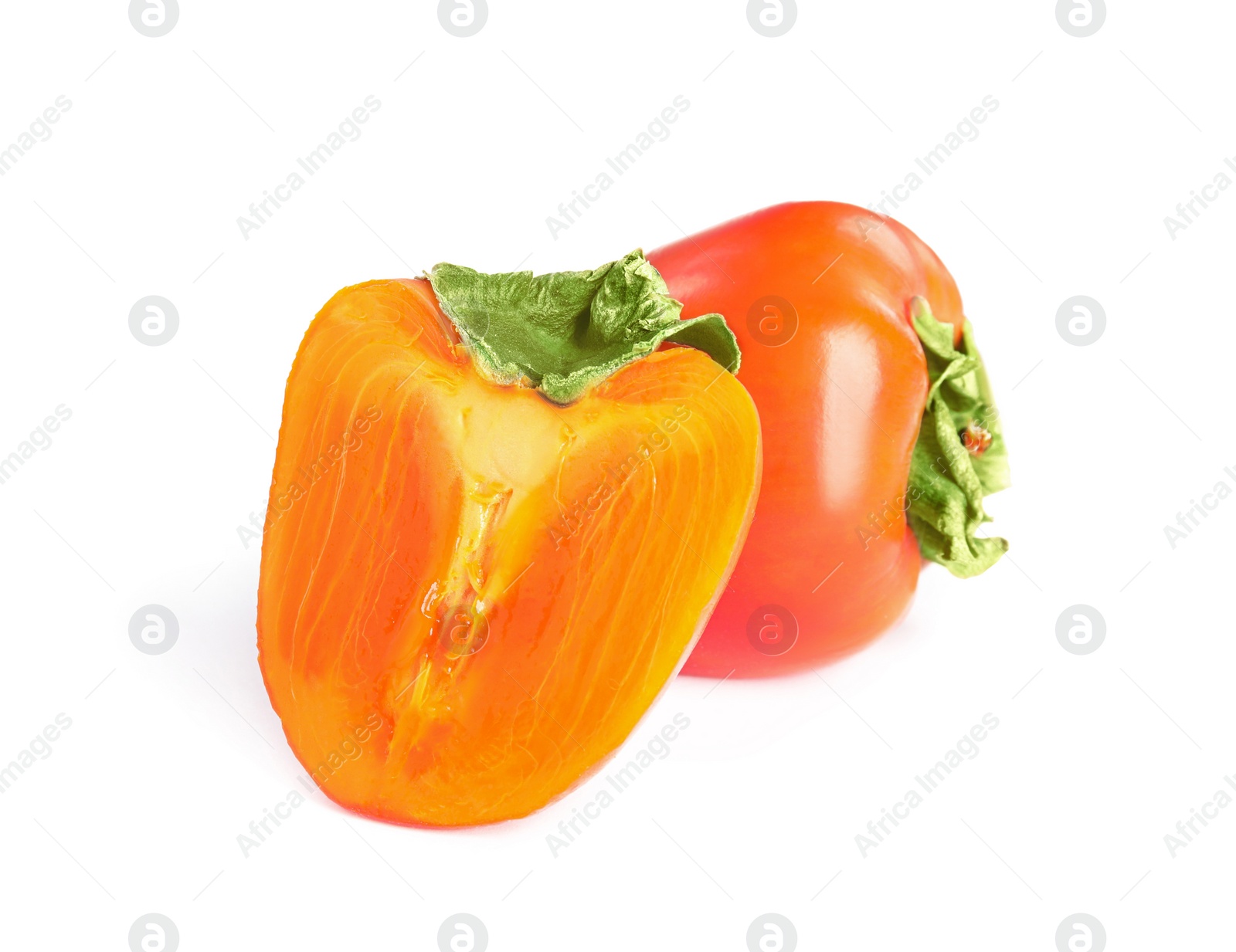 Delicious cut and whole fresh ripe persimmons isolated on white Photo of Delicious cut and whole fresh ripe persimmons isolated on white