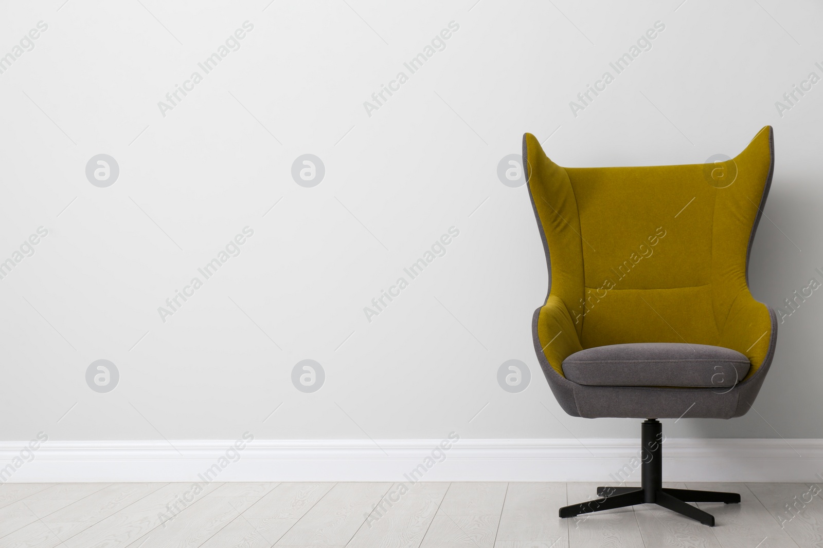 Comfortable office chair near light wall indoors. Space for text Photo of Comfortable office chair near light wall indoors. Space for text