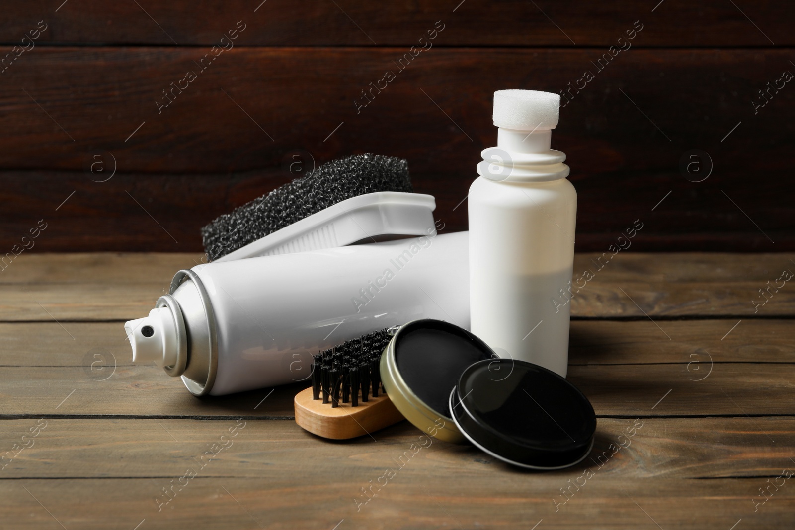 Composition with shoe care accessories on wooden table Photo of Composition with shoe care accessories on wooden table