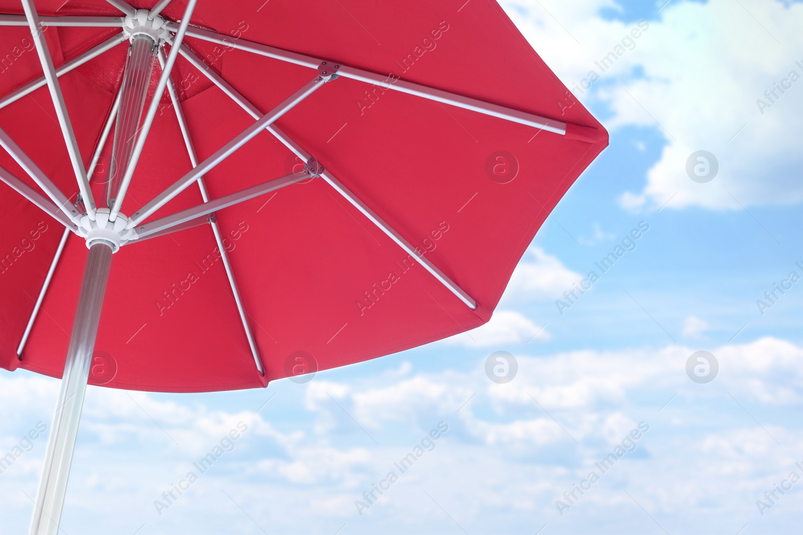 View of red umbrella and blue sky on sunny day Photo of View of red umbrella and blue sky on sunny day