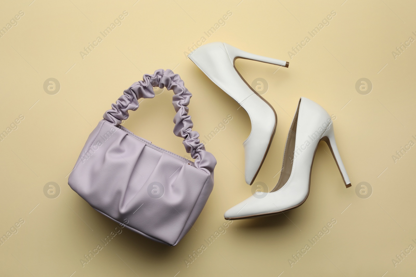 Stylish woman's bag and shoes on beige background, flat lay Photo of Stylish woman's bag and shoes on beige background, flat lay