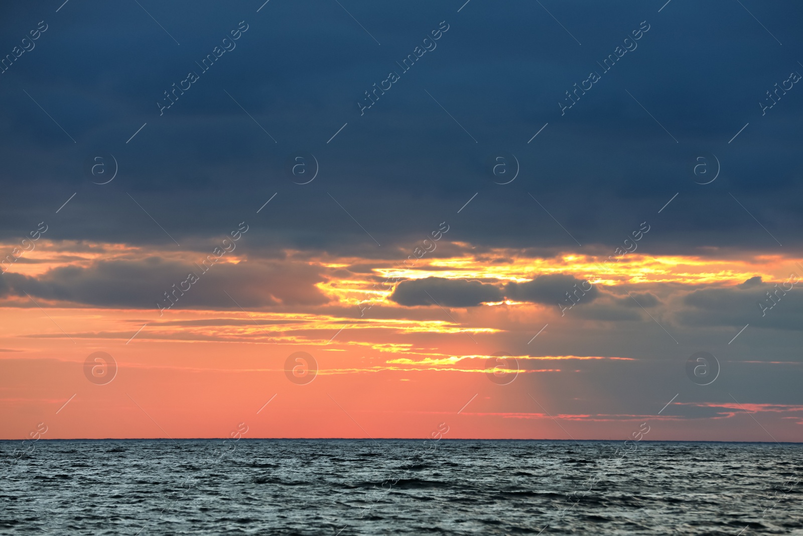 Picturesque view of beautiful sky with clouds over sea at sunset Photo of Picturesque view of beautiful sky with clouds over sea at sunset