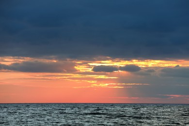 Picturesque view of beautiful sky with clouds over sea at sunset Photo of Picturesque view of beautiful sky with clouds over sea at sunset