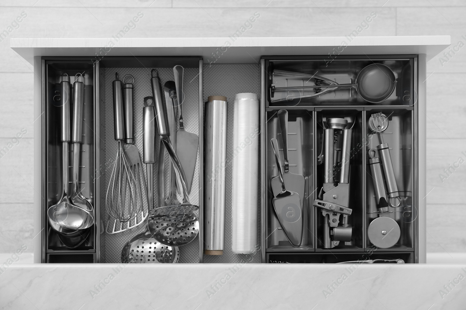 Drawer with stainless steel utensil set, top view. Order in kitchen Photo of Drawer with stainless steel utensil set, top view. Order in kitchen