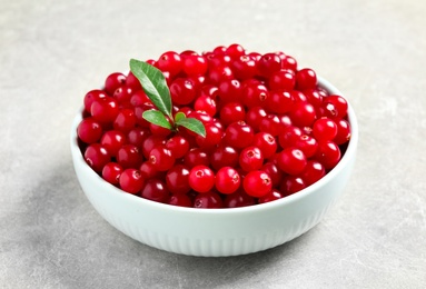 Tasty ripe cranberries on grey table, closeup Photo of Tasty ripe cranberries on grey table, closeup
