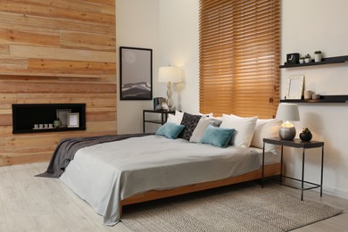 Stylish room interior with big comfortable bed Photo of Stylish room interior with big comfortable bed