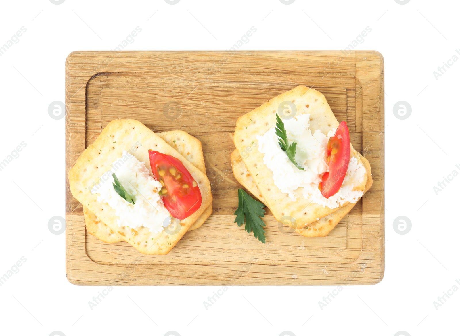 Delicious crackers with cream cheese, tomato and parsley on white background, top view Photo of Delicious crackers with cream cheese, tomato and parsley on white background, top view