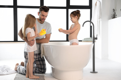 Young father with little daughters in bathroom Photo of Young father with little daughters in bathroom