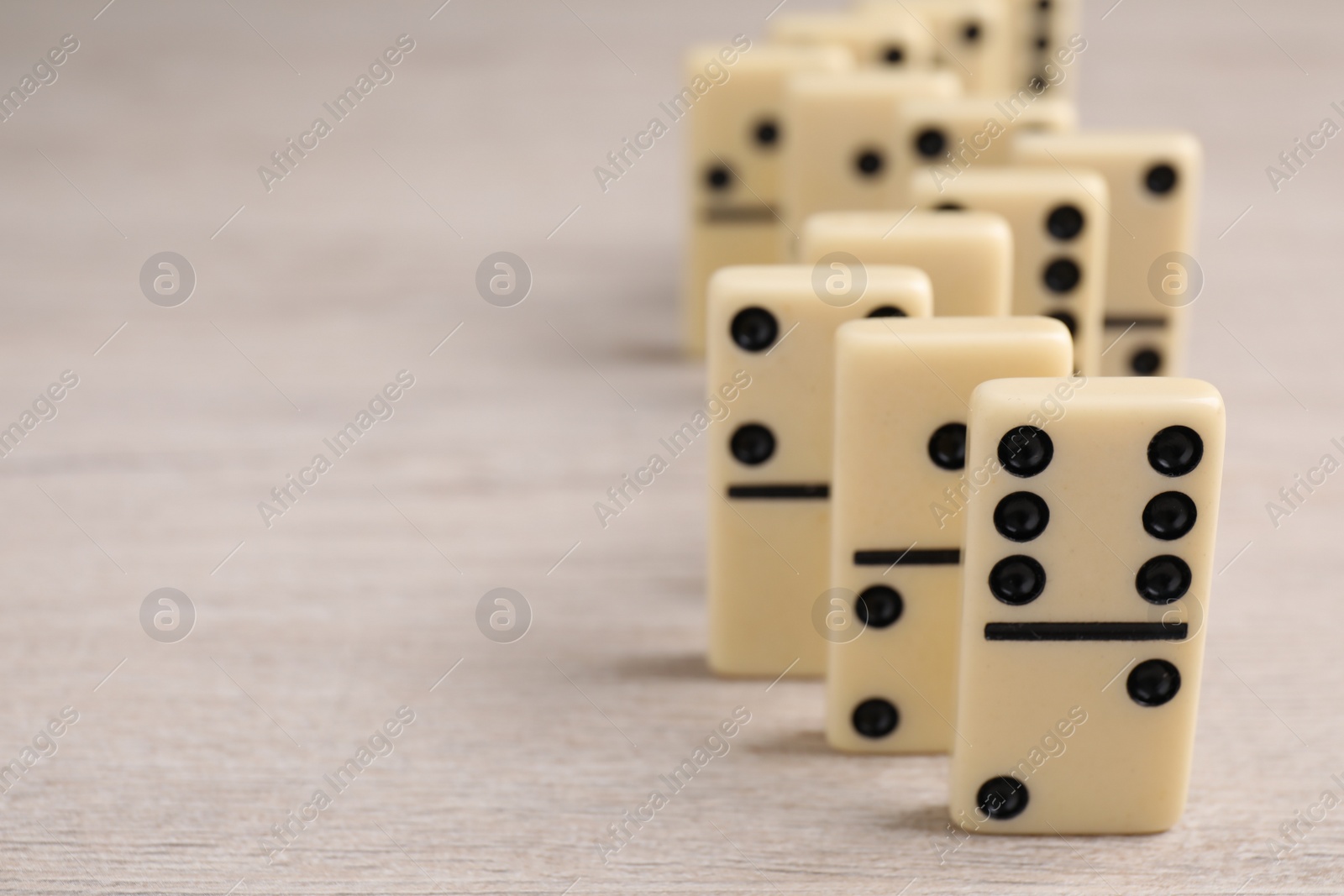 Domino tiles on wooden table, closeup. Space for text Photo of Domino tiles on wooden table, closeup. Space for text
