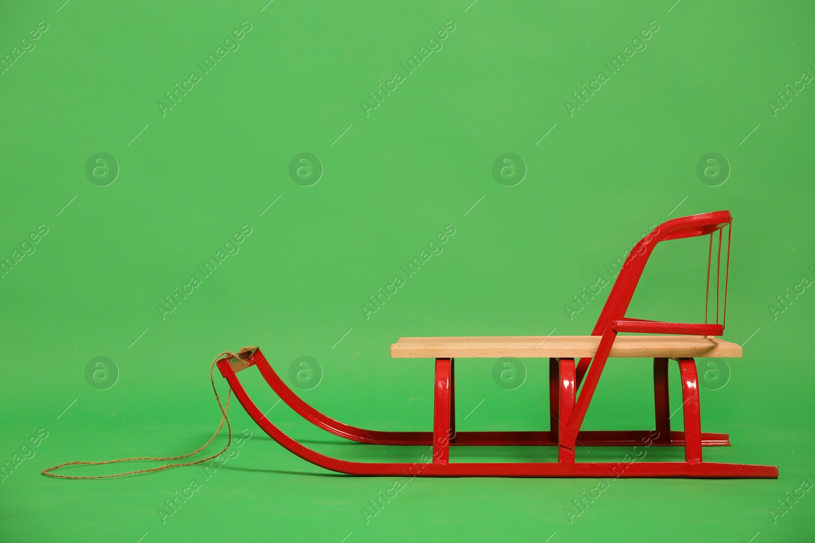 Empty sleigh on green background. Winter activity Photo of Empty sleigh on green background. Winter activity
