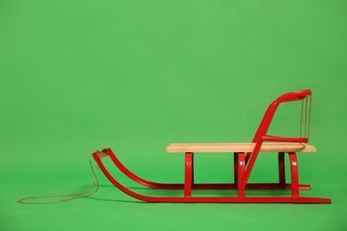 Empty sleigh on green background. Winter activity Photo of Empty sleigh on green background. Winter activity