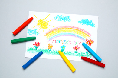 Drawing for Mother's day and crayons on light grey background, flat lay Photo of Drawing for Mother's day and crayons on light grey background, flat lay