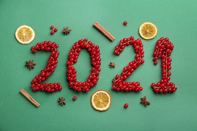 2012 made of cranberries on green background, flat lay Photo of 2012 made of cranberries on green background, flat lay