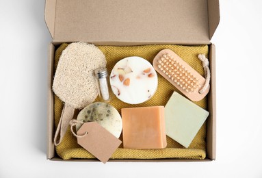 Cardboard box with eco friendly personal care products on white background, top view Photo of Cardboard box with eco friendly personal care products on white background, top view