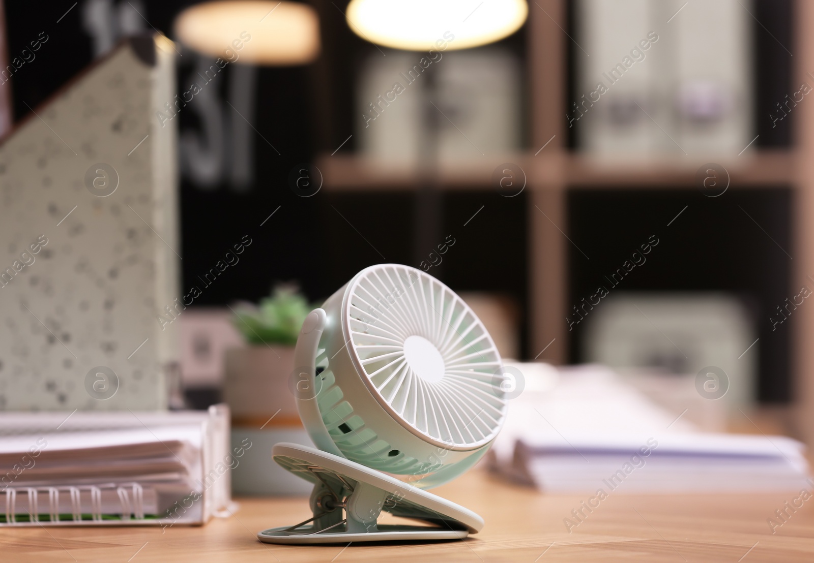Modern electric fan on table in office Photo of Modern electric fan on table in office