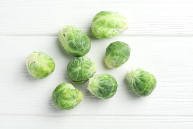Fresh Brussels sprouts on white wooden table, flat lay Photo of Fresh Brussels sprouts on white wooden table, flat lay