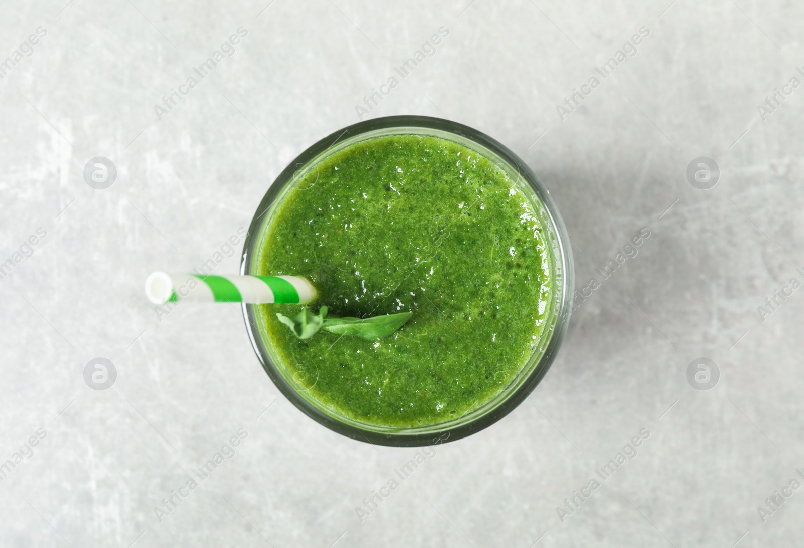 Fresh green juice on light grey table, top view Photo of Fresh green juice on light grey table, top view