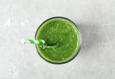Fresh green juice on light grey table, top view Photo of Fresh green juice on light grey table, top view