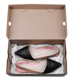 Pair of stylish shoes in cardboard box on white background, top view Photo of Pair of stylish shoes in cardboard box on white background, top view
