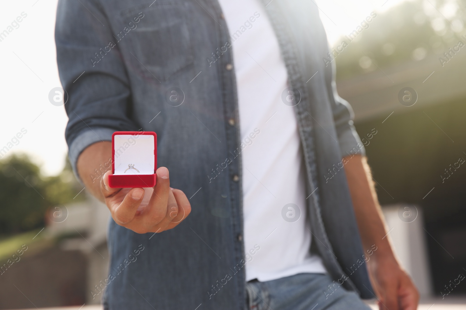 Man with beautiful engagement ring outdoors, closeup Photo of Man with beautiful engagement ring outdoors, closeup