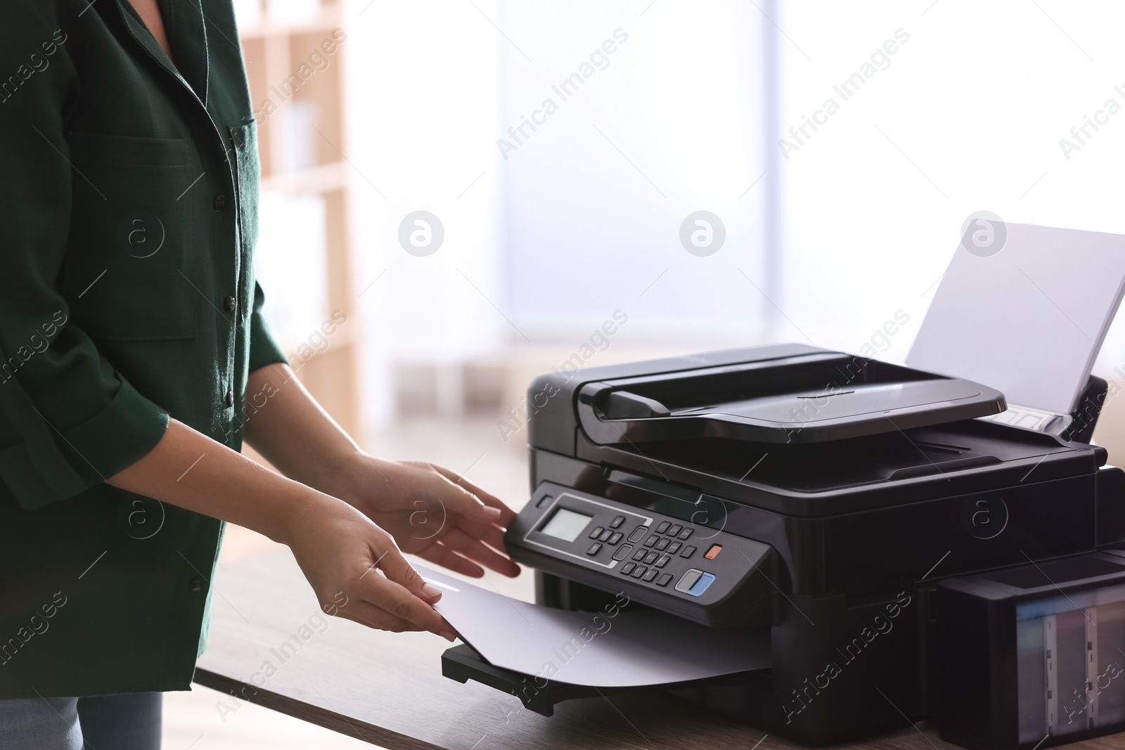 Employee using modern printer in office, closeup Photo of Employee using modern printer in office, closeup