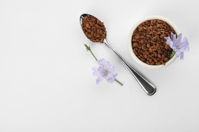 Chicory granules and flowers on white background, top view Photo of Chicory granules and flowers on white background, top view