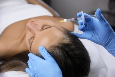 Beautiful woman getting facial injection in salon Photo of Beautiful woman getting facial injection in salon