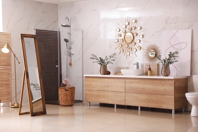 Modern bathroom interior with stylish mirror and vessel sink Photo of Modern bathroom interior with stylish mirror and vessel sink