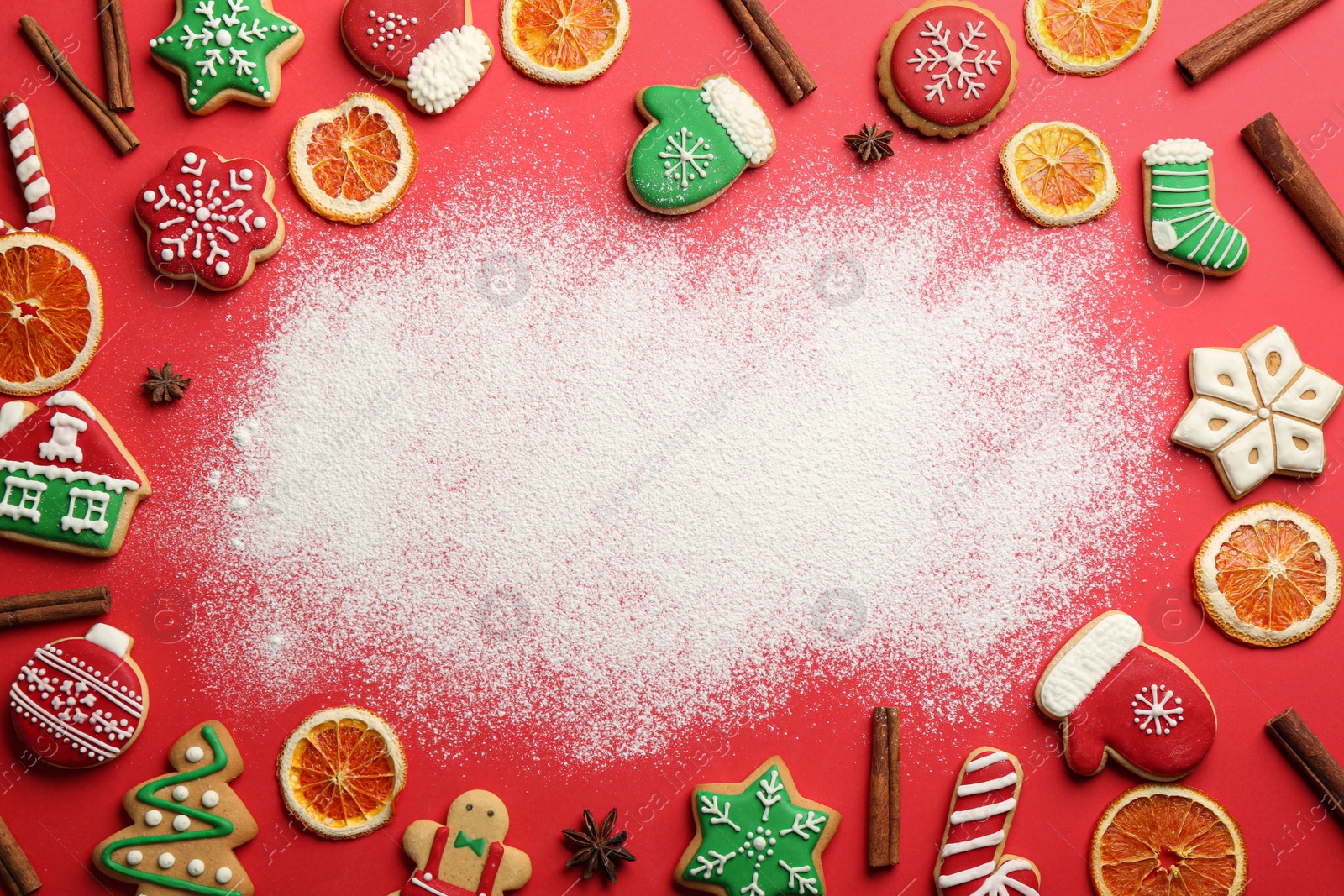 Frame of Christmas cookies and flour on red background, flat lay. Space for text Photo of Frame of Christmas cookies and flour on red background, flat lay. Space for text