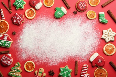 Frame of Christmas cookies and flour on red background, flat lay. Space for text Photo of Frame of Christmas cookies and flour on red background, flat lay. Space for text