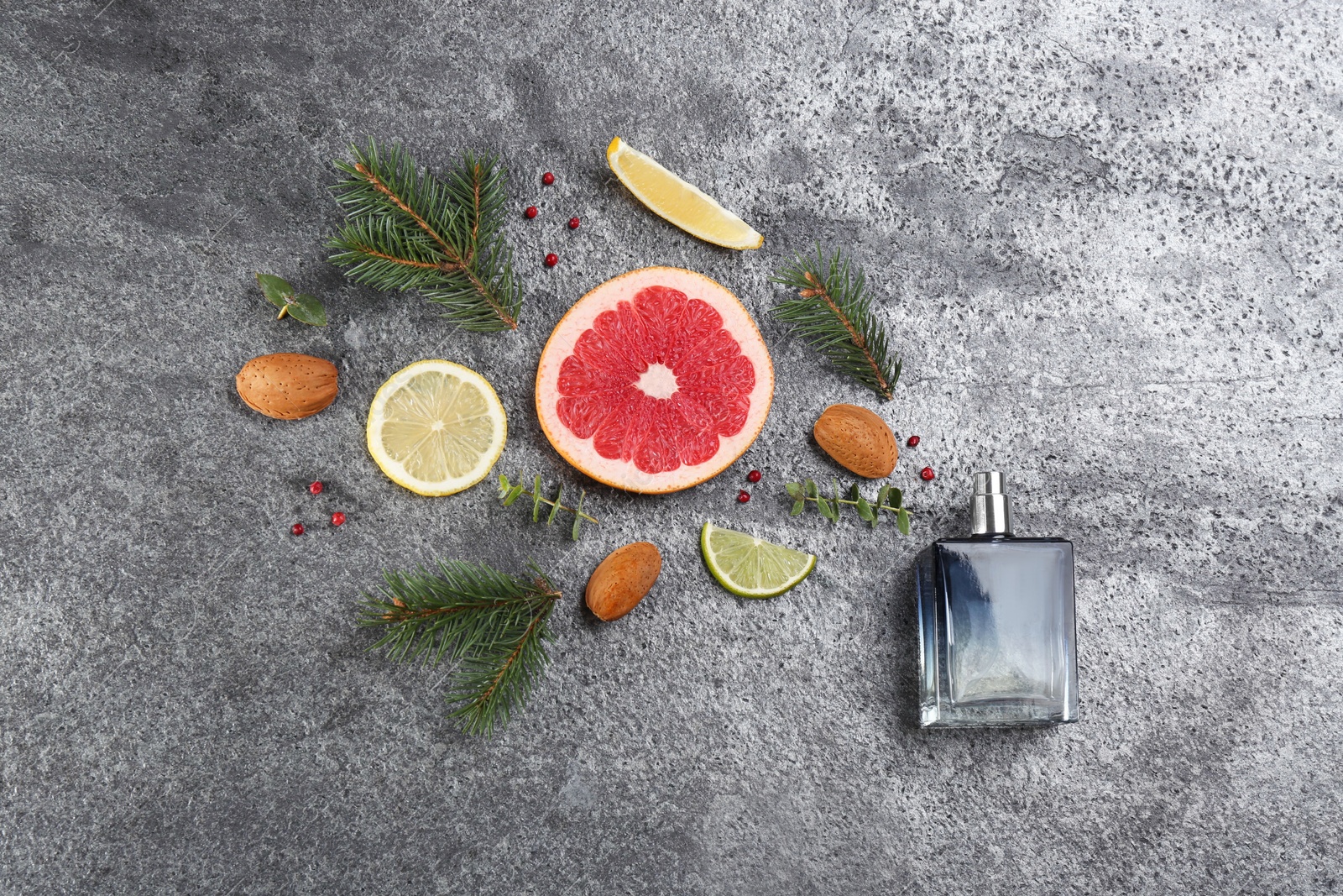 Photo of Flat lay composition with bottle of perfume on grey background