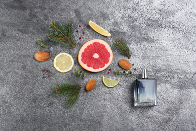 Flat lay composition with bottle of perfume on grey background Photo of Flat lay composition with bottle of perfume on grey background