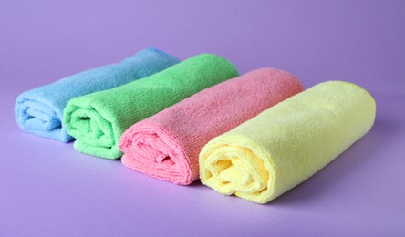 Many colorful microfiber cloths on light background Photo of Many colorful microfiber cloths on light background
