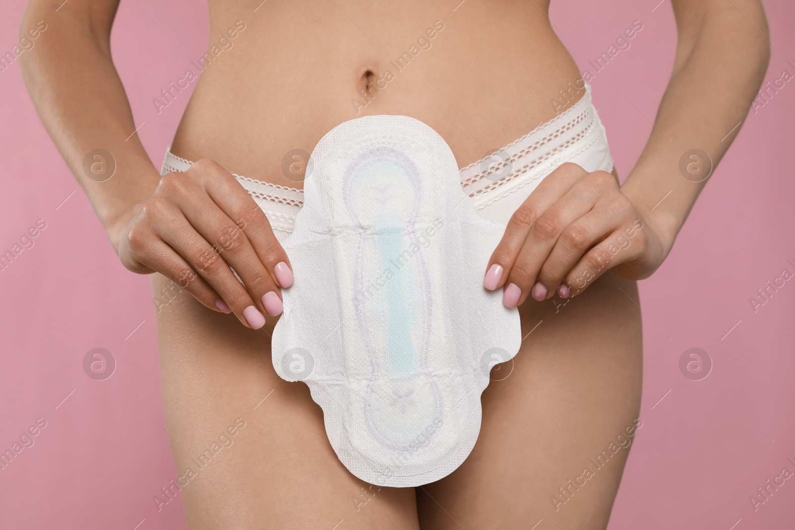 Photo of Woman in white panties with menstrual pad on pink background, closeup