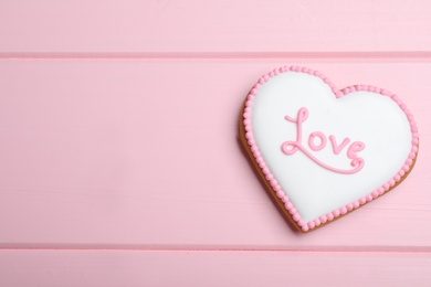 Valentine's day cookie with word Love on pink table, top view. Space for text Photo of Valentine's day cookie with word Love on pink table, top view. Space for text