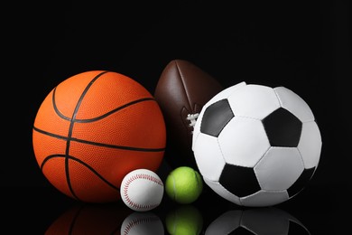 Set of different sport balls on black mirror surface Photo of Set of different sport balls on black mirror surface