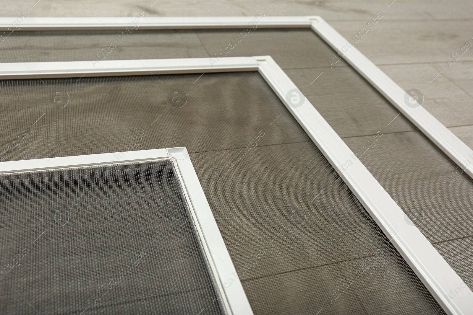 Set of window screens on wooden floor, closeup Photo of Set of window screens on wooden floor, closeup