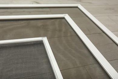 Set of window screens on wooden floor, closeup Photo of Set of window screens on wooden floor, closeup