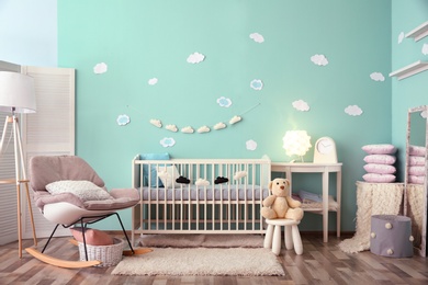 Modern baby room interior with crib and rocking chair Photo of Modern baby room interior with crib and rocking chair