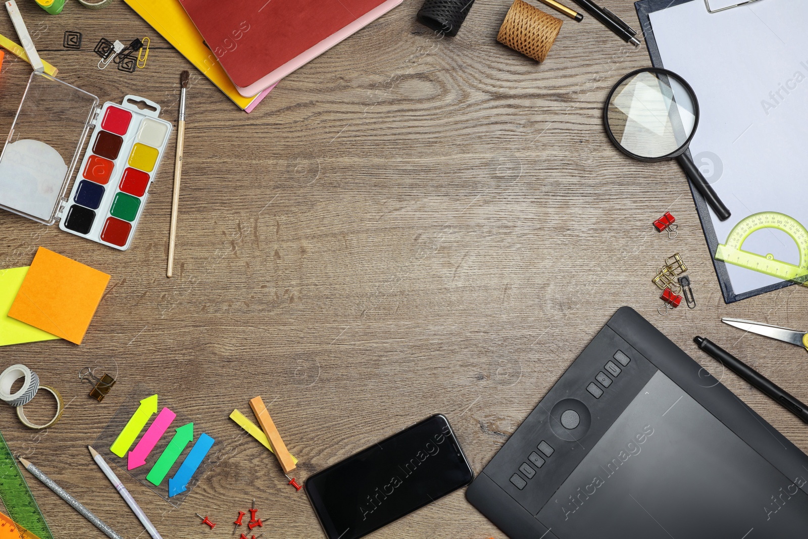 Flat lay composition with graphics tablet and stationery on wooden table, space for text. Designer's workplace Photo of Flat lay composition with graphics tablet and stationery on wooden table, space for text. Designer's workplace
