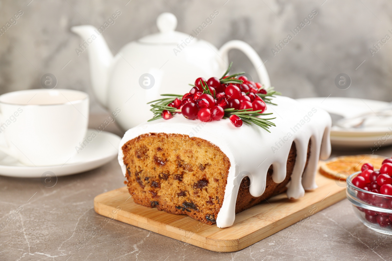 Traditional classic Christmas cake decorated with cranberries, pomegranate seeds and rosemary served on table Photo of Traditional classic Christmas cake decorated with cranberries, pomegranate seeds and rosemary served on table