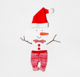 Creative snowman shape made of Santa hat and different items on white background, flat lay Photo of Creative snowman shape made of Santa hat and different items on white background, flat lay
