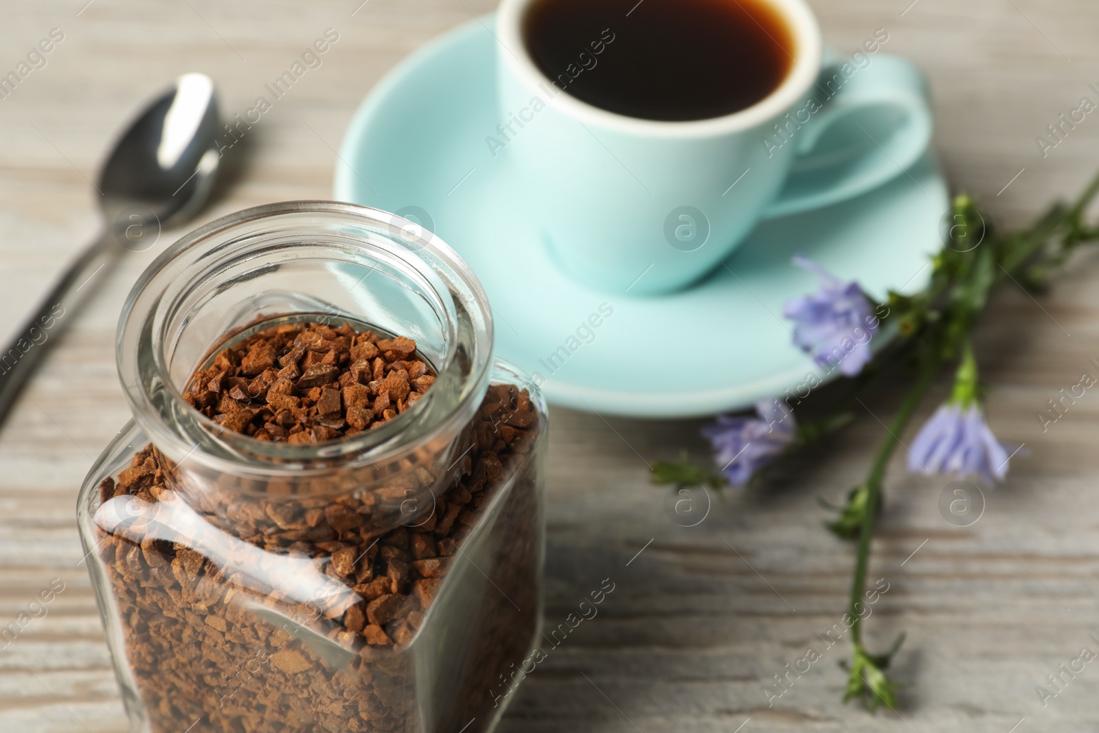 Jar of chicory granules on white wooden table, closeup. Space for text Photo of Jar of chicory granules on white wooden table, closeup. Space for text