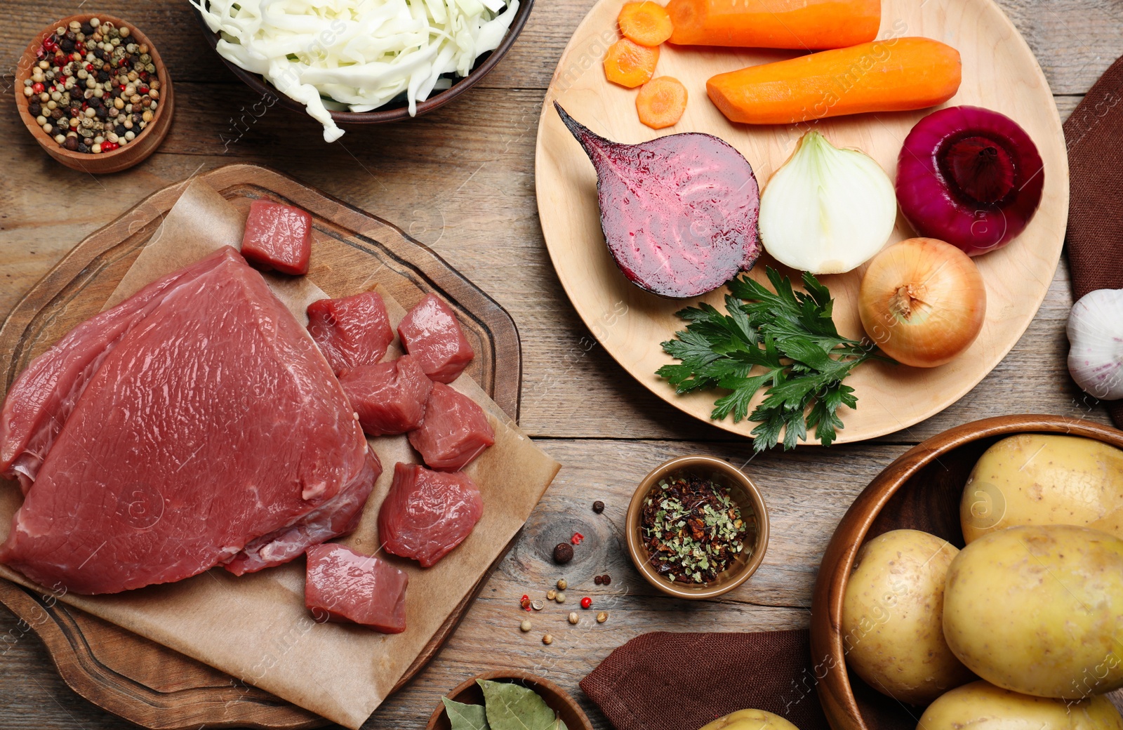 Fresh ingredients for borscht on wooden table, flat lay Photo of Fresh ingredients for borscht on wooden table, flat lay