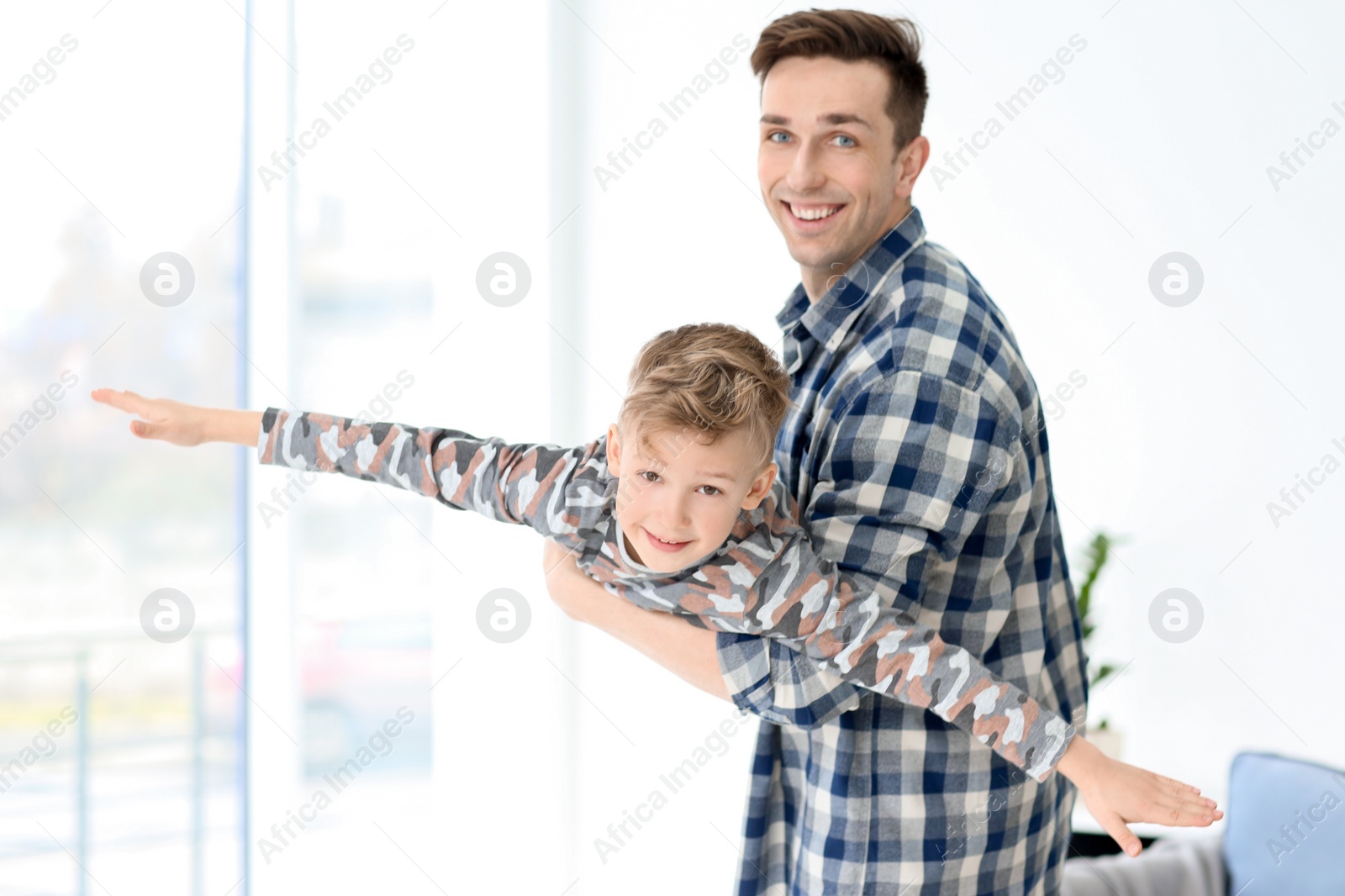 Dad and his son playing at home Photo of Dad and his son playing at home