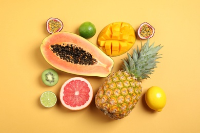 Fresh ripe papaya and other fruits on yellow background. flat lay Photo of Fresh ripe papaya and other fruits on yellow background. flat lay