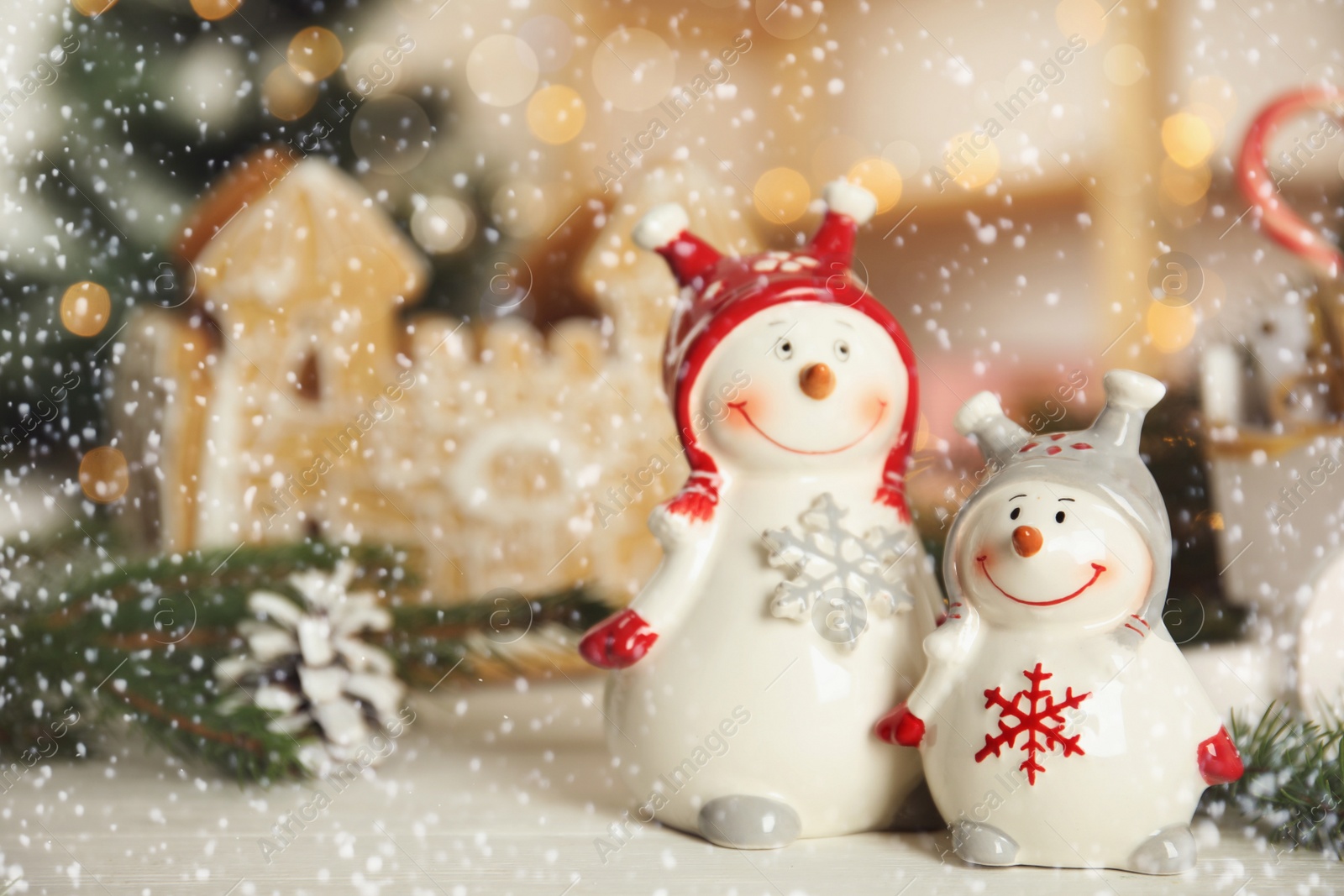 Photo of Christmas composition with decorative snowmen on white wooden table, space for text